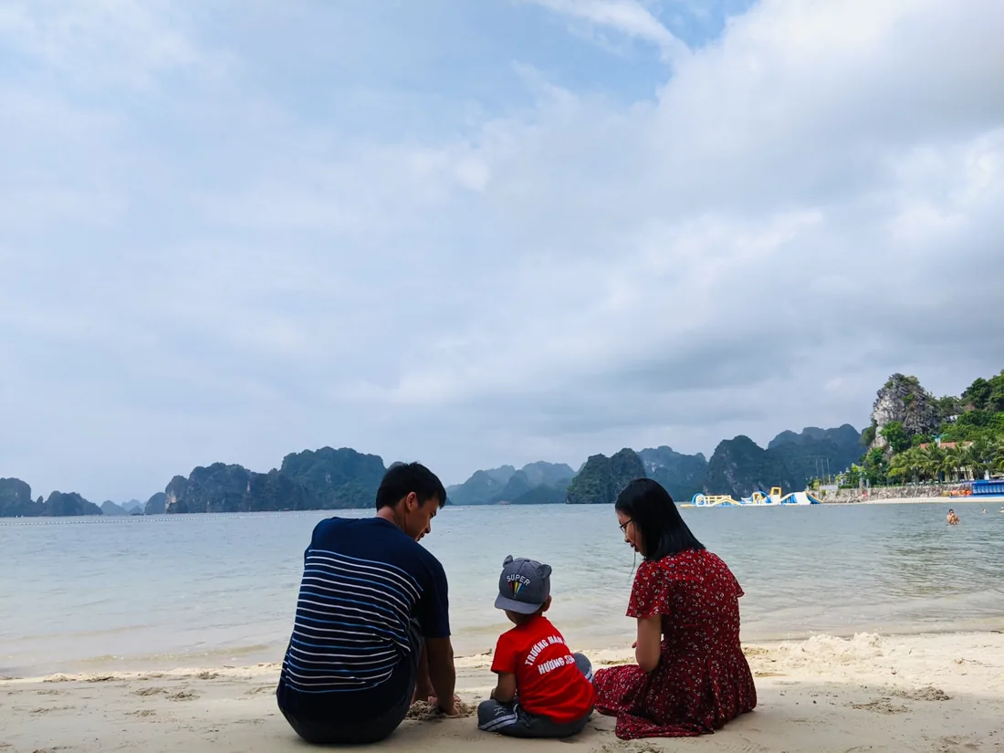 Gia đình ngồi bên nhau trên bãi biển
